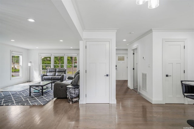 living room featuring dark hardwood / wood-style floors and crown molding