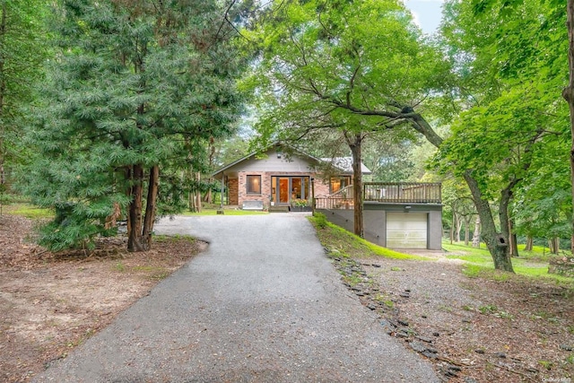 view of front facade with a garage and a deck