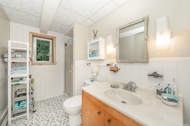 bathroom featuring a baseboard radiator, vanity, tile walls, toilet, and walk in shower