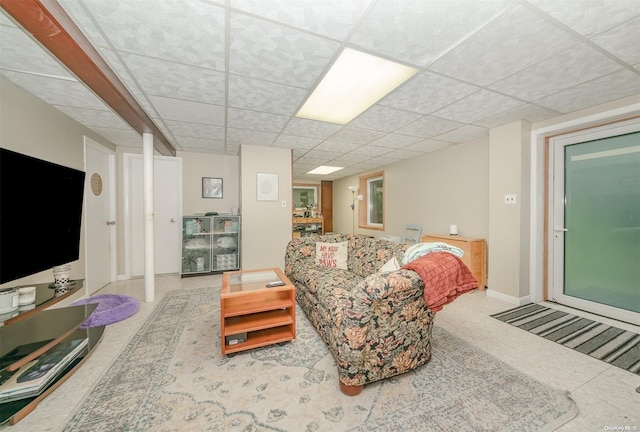 living room with a drop ceiling