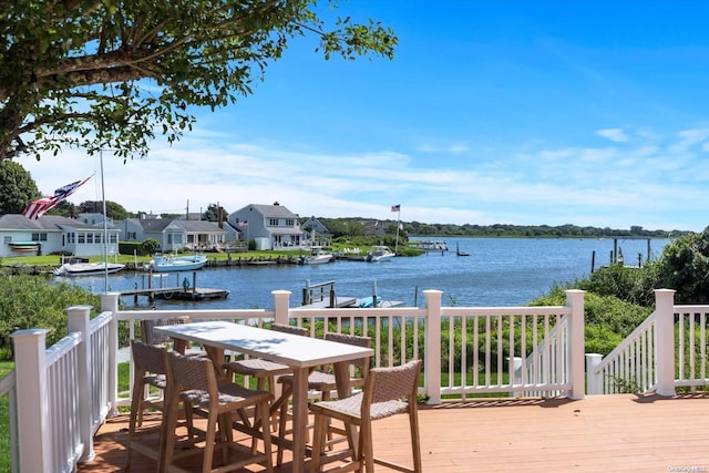 wooden terrace featuring a water view