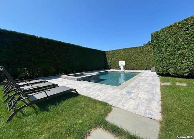 view of swimming pool featuring a patio area and an in ground hot tub