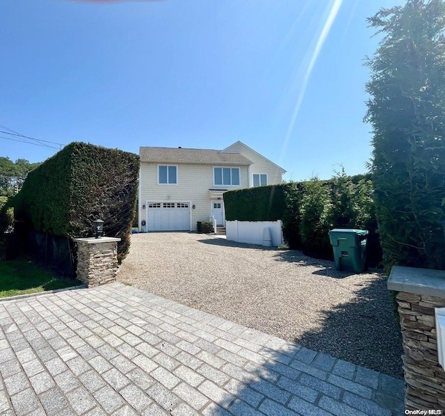 back of property featuring a garage