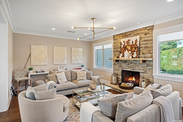 living room featuring ornamental molding, a stone fireplace, and dark wood-type flooring