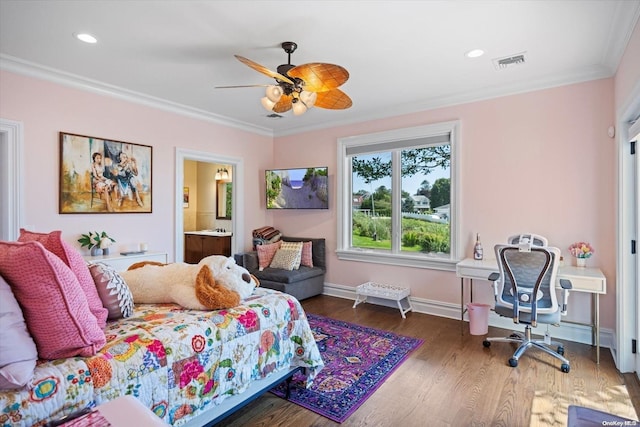 bedroom with ensuite bath, ceiling fan, dark wood-type flooring, and crown molding