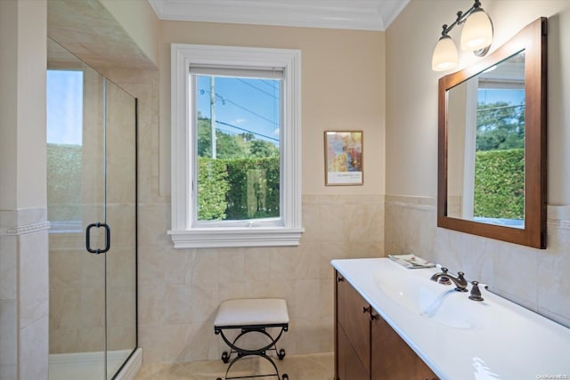 bathroom featuring vanity, an enclosed shower, ornamental molding, and tile walls