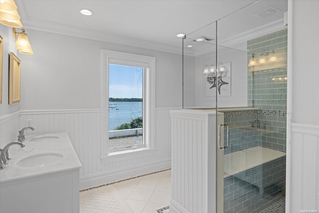 bathroom with walk in shower, tile patterned flooring, crown molding, a water view, and vanity