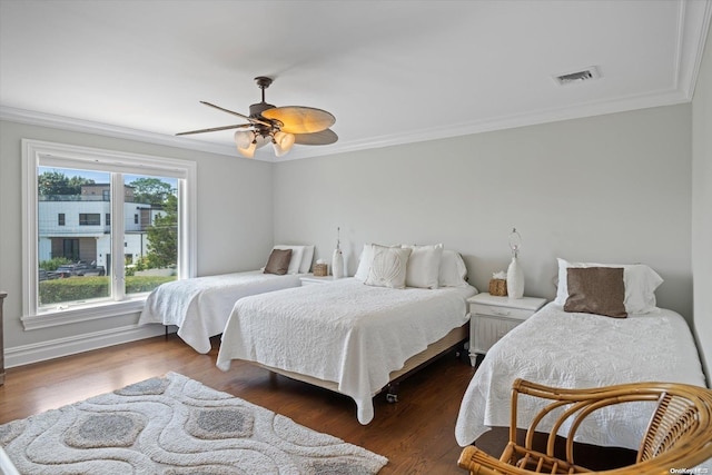 bedroom featuring ceiling fan, dark hardwood / wood-style floors, and ornamental molding