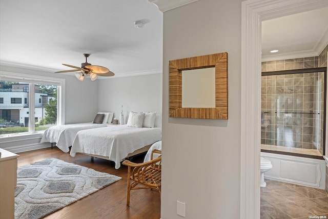 bedroom featuring hardwood / wood-style flooring, ceiling fan, crown molding, and connected bathroom