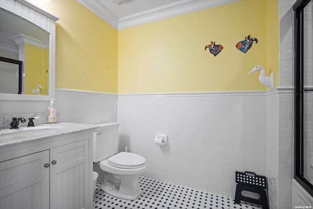 bathroom featuring tile patterned floors, vanity, toilet, and crown molding