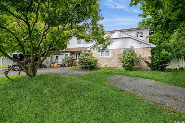 obstructed view of property with a front lawn