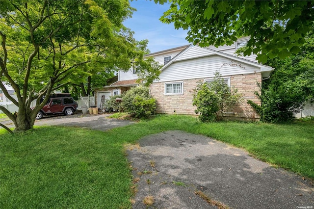 view of property exterior with a yard