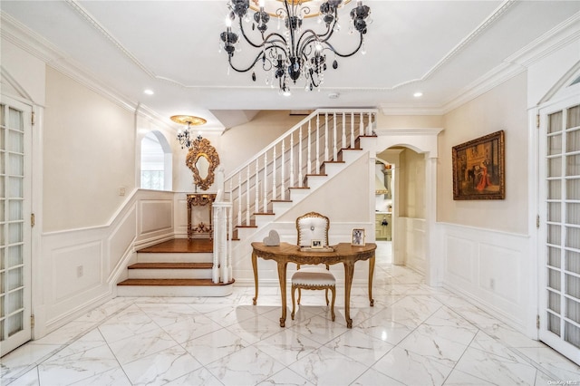 stairs featuring a notable chandelier and ornamental molding