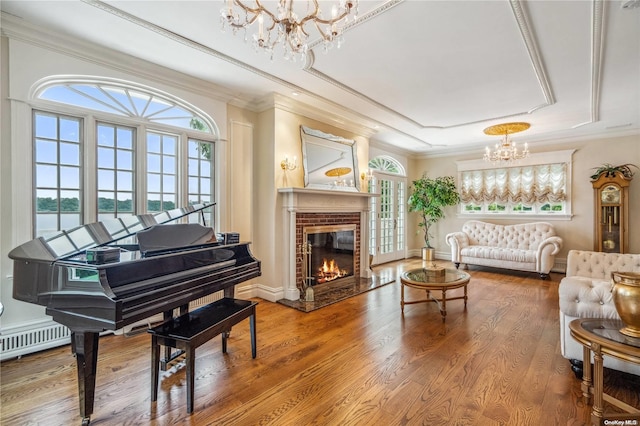 living area featuring hardwood / wood-style flooring, crown molding, and a wealth of natural light