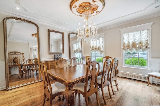 dining space featuring a chandelier, light hardwood / wood-style flooring, and ornamental molding