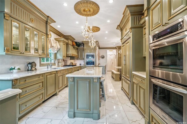 kitchen with a kitchen island, crown molding, hanging light fixtures, and stainless steel appliances