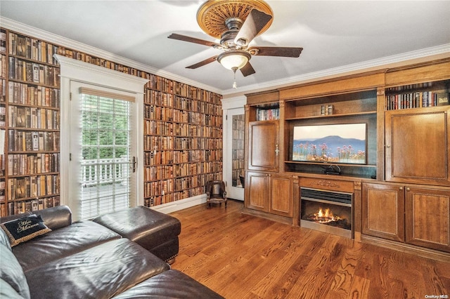 living room featuring crown molding, ceiling fan, and dark hardwood / wood-style floors