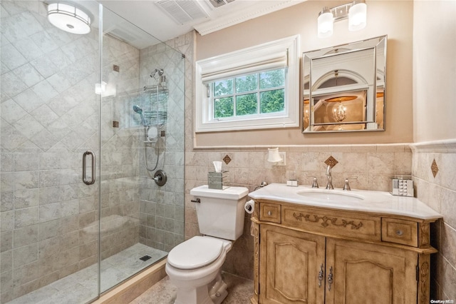 bathroom with vanity, toilet, tile walls, and a shower with shower door