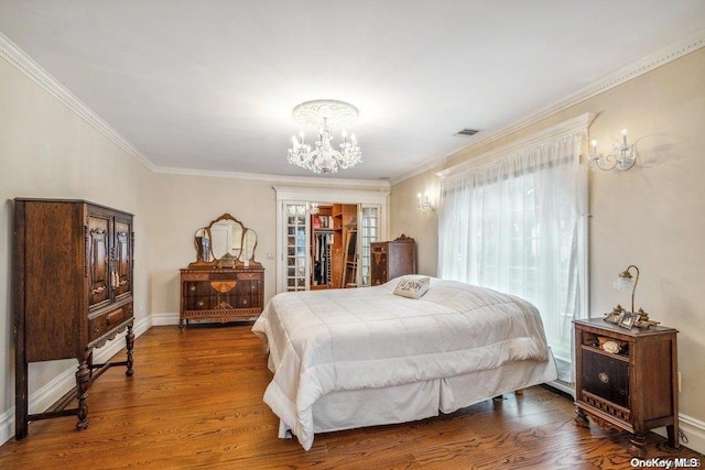 bedroom with hardwood / wood-style flooring and crown molding