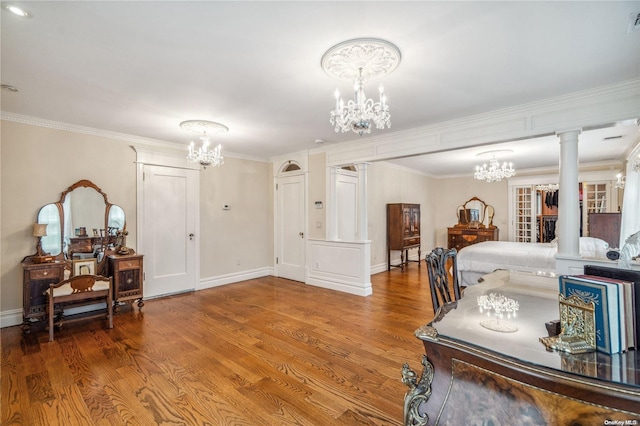 interior space featuring hardwood / wood-style floors, crown molding, and decorative columns