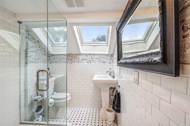 bathroom featuring toilet, tile walls, walk in shower, and a skylight