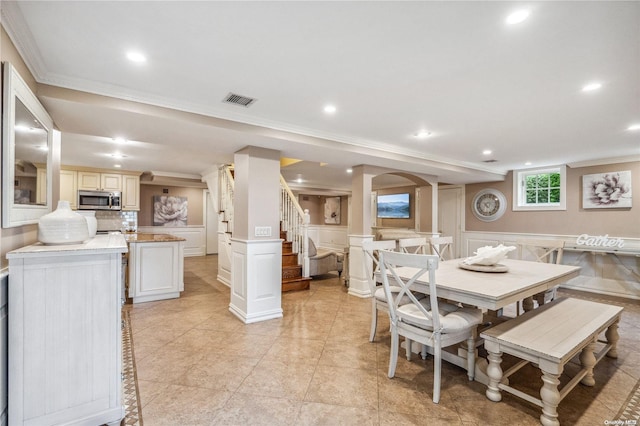 dining room featuring light tile patterned floors and ornamental molding