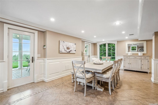 dining room with light tile patterned floors and crown molding