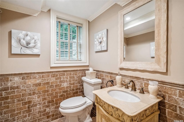 bathroom featuring vanity, toilet, tile walls, and ornamental molding