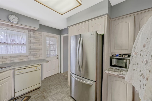 kitchen with dishwasher, stainless steel fridge, and light parquet floors