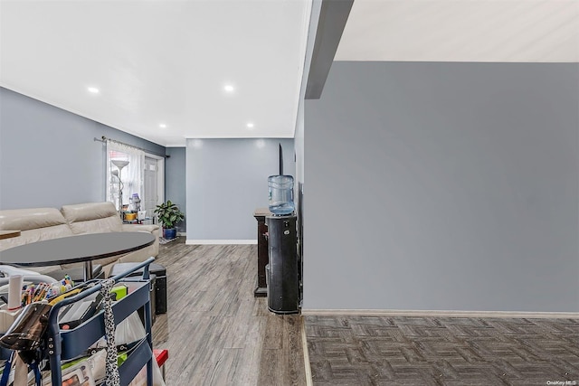 living room with hardwood / wood-style floors and crown molding