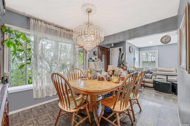 dining area featuring parquet floors and an inviting chandelier