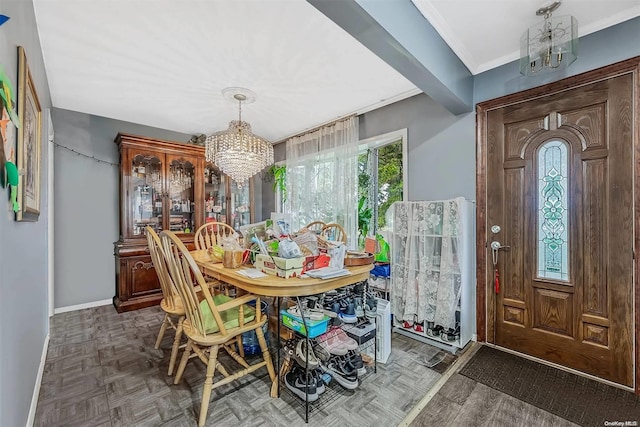 dining area featuring dark parquet flooring, a chandelier, and ornamental molding