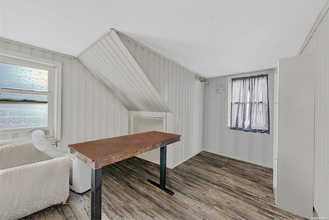 home office featuring lofted ceiling, wood-type flooring, and wooden walls