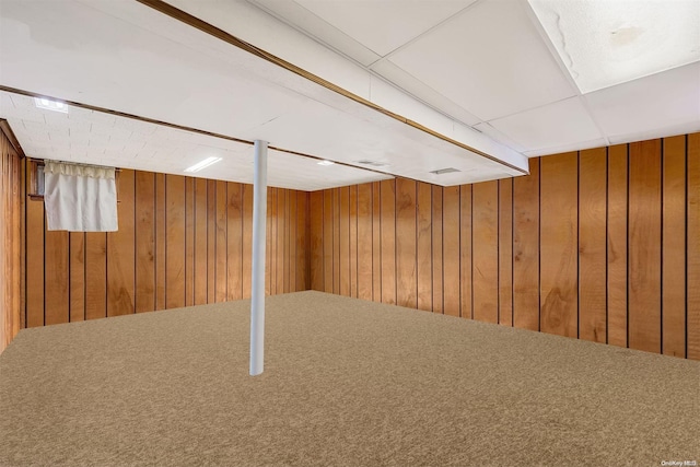 basement with wooden walls and carpet