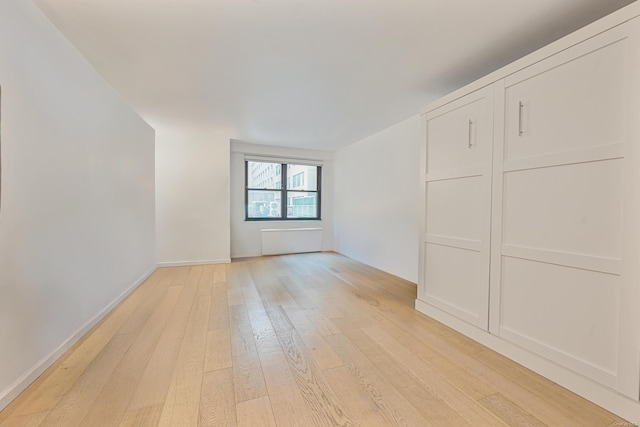 unfurnished room with light wood-type flooring