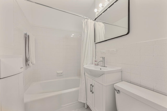 full bathroom with vanity, toilet, shower / tub combo, and tile walls