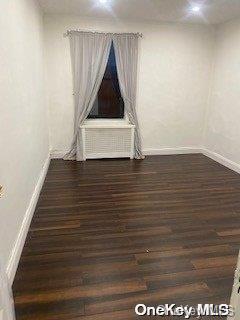 spare room featuring dark hardwood / wood-style floors