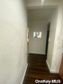 hallway with dark hardwood / wood-style floors