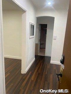 corridor featuring dark hardwood / wood-style floors