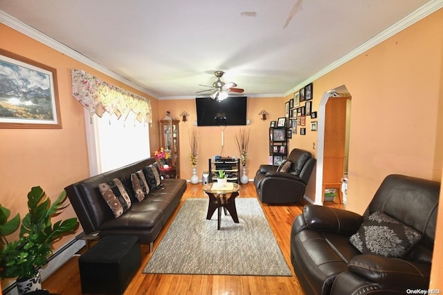 living room with ceiling fan, hardwood / wood-style floors, a baseboard heating unit, and ornamental molding