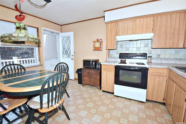 kitchen featuring exhaust hood, white range with electric cooktop, crown molding, decorative backsplash, and tile counters