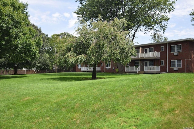 view of yard featuring a balcony