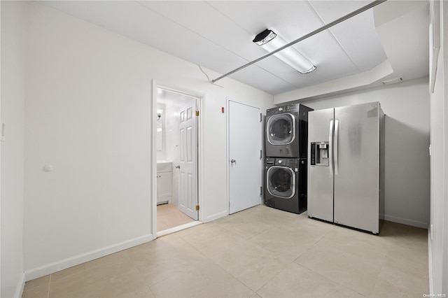 laundry area with stacked washer and dryer