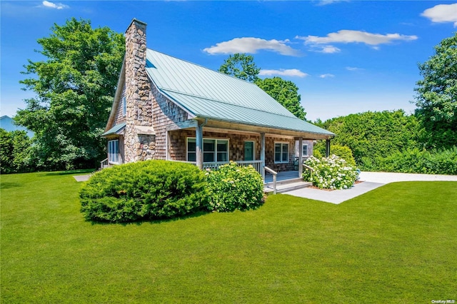 back of house with a lawn and covered porch