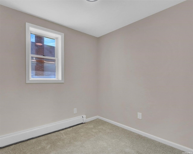 carpeted empty room featuring a baseboard radiator