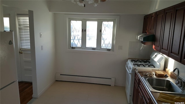 kitchen with white appliances, sink, light wood-type flooring, a baseboard radiator, and extractor fan