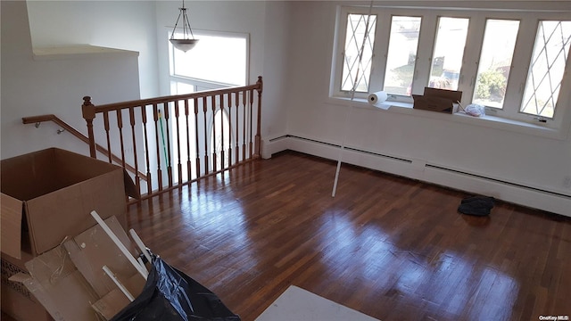 interior space with a baseboard radiator and dark wood-type flooring