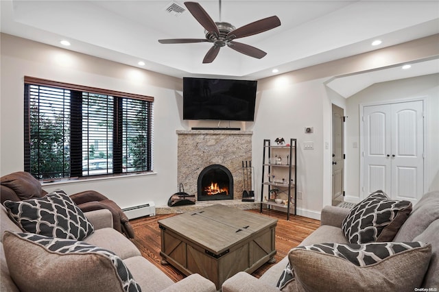 living room with baseboard heating, ceiling fan, hardwood / wood-style floors, and a premium fireplace