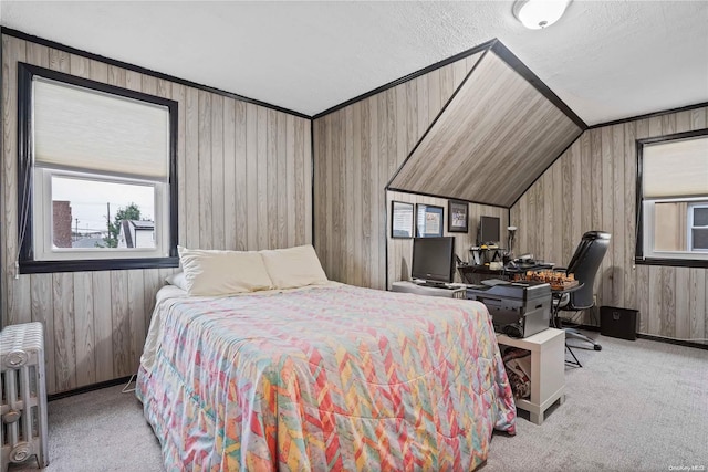 bedroom with light colored carpet, radiator, lofted ceiling, and wood walls