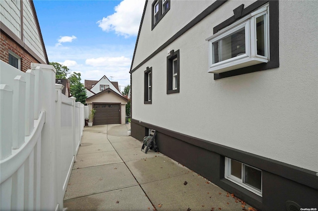 view of home's exterior with a garage and an outdoor structure